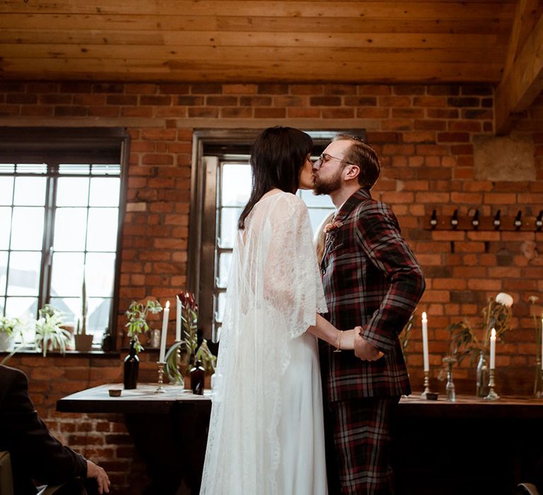 Bride & groom kiss on their wedding day at The Chimney House 