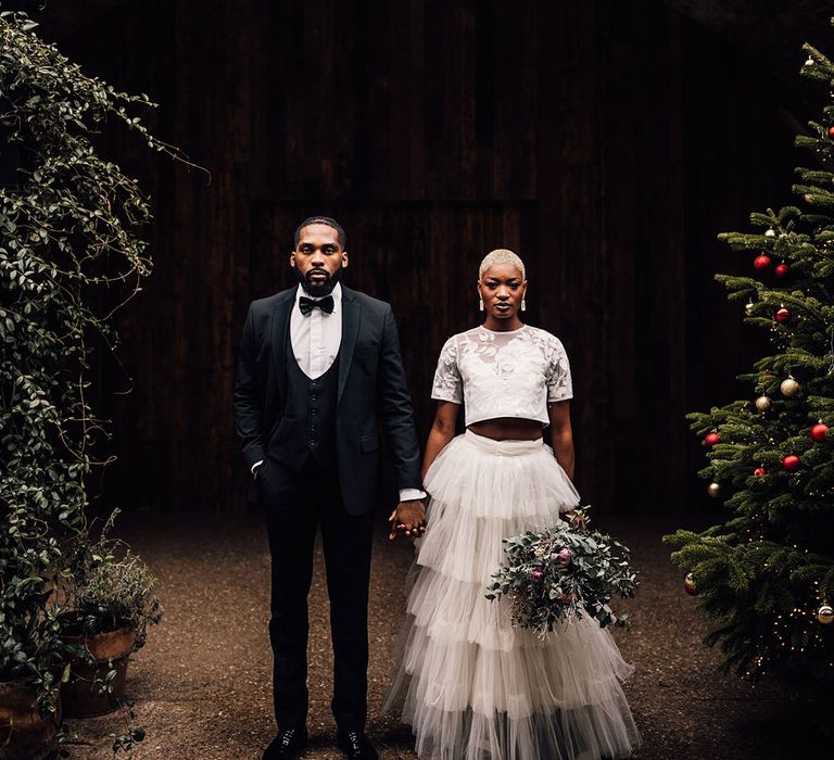 Bride and Groom hold hands in moody lighting at London wedding venue, 100 Barrington