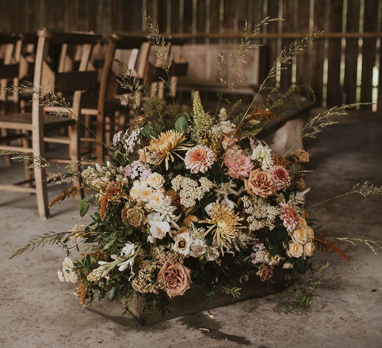 Pink, orange, yellow, and brown wedding flower arrangement for rustic barn wedding 