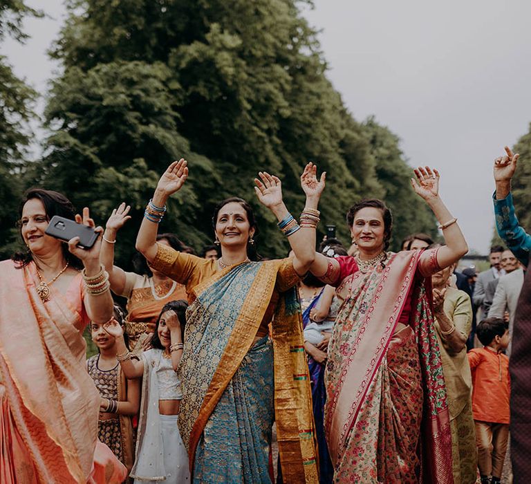 Wedding guests dance outdoors at Braxted Park Estate for Hindu and Sri Lankan wedding 