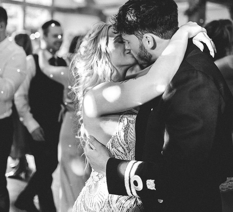 The bride and groom share an intimate kiss as they have their first dance together 