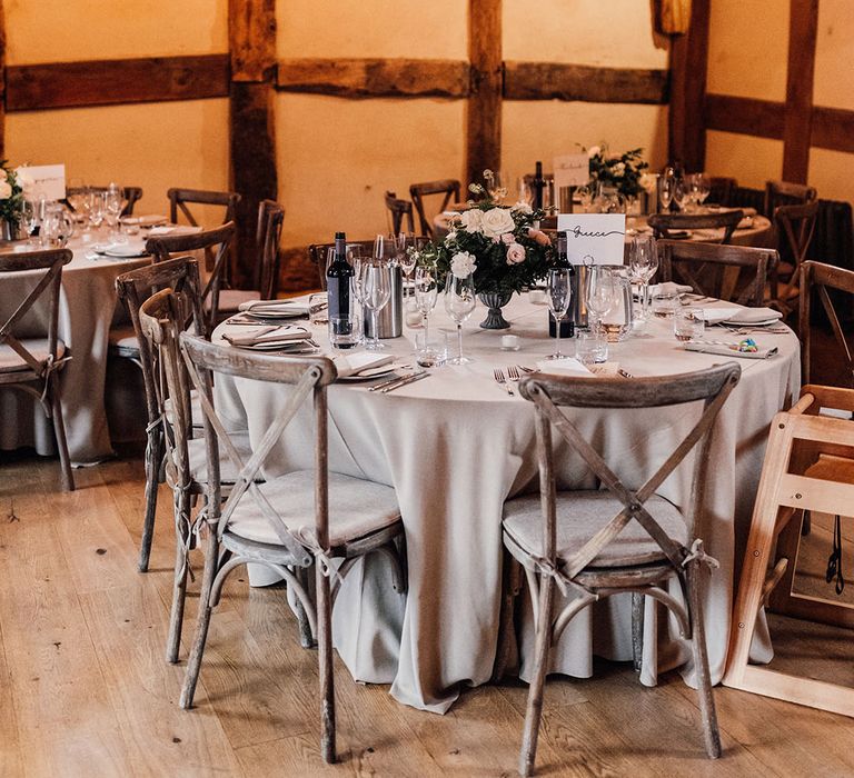 Grey wedding tablescape with grey tablecloth and silver cutlery at Hanley Hall in Worcestershire with festoon lighting 