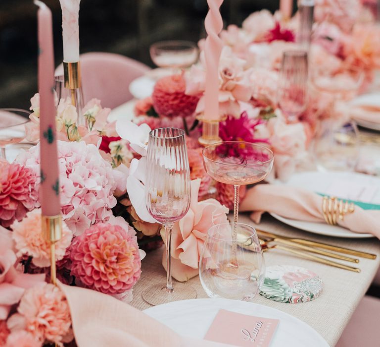 Pink wedding theme with hydrangeas, dahlias, roses, with twisted candle, cactus pink candles, pink glassware and pink plates