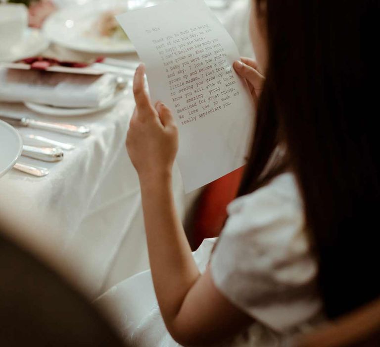 Wedding guest reading personalised wedding letter favour at Inner Temple Hall vow renewal 