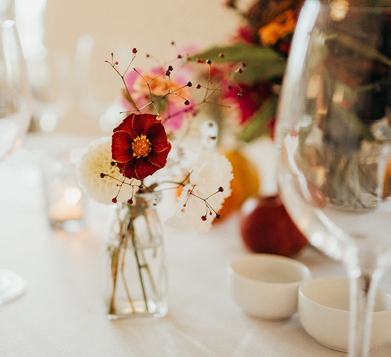 Mini bud vase decorations for Coombe Lodge wedding with simple decorations 