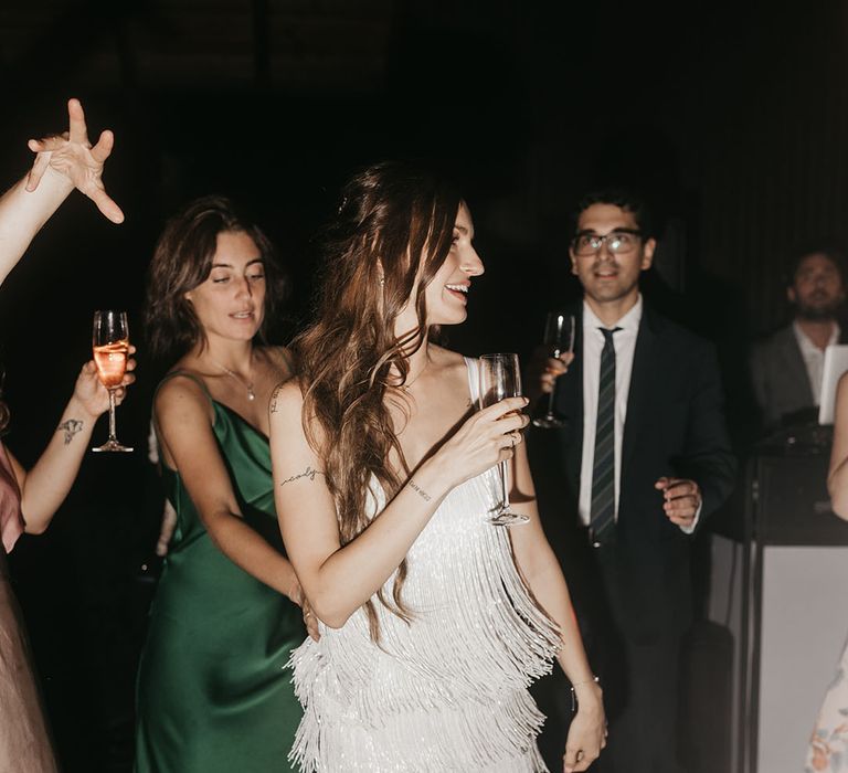 bride in a short tassel wedding reception dress at the evening reception 