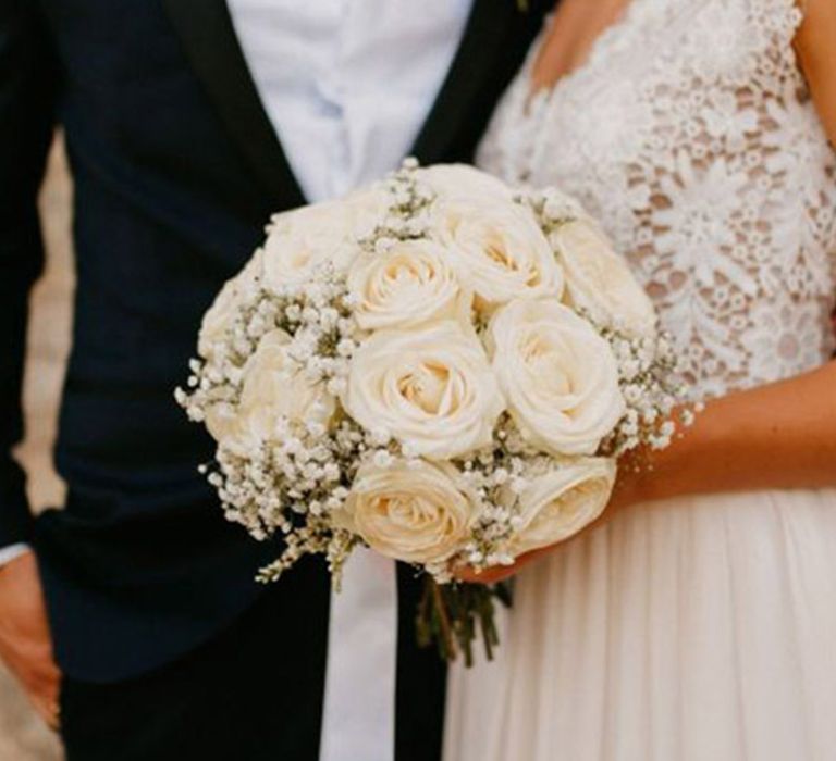 Small round white rose and gypsophila bouquet for traditional and grand castle wedding