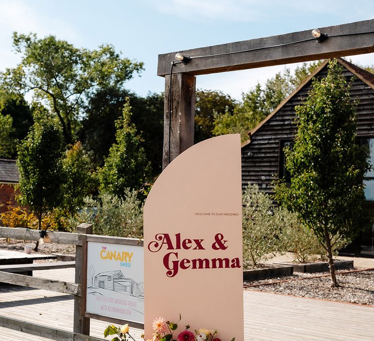 Cream and red wedding welcome sign with flowers 