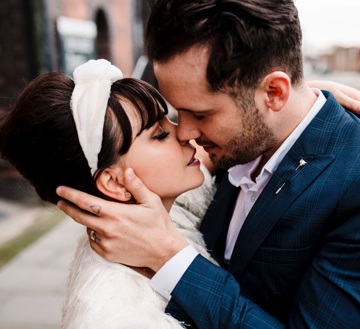 Intimate portrait of bride and groom kissing 