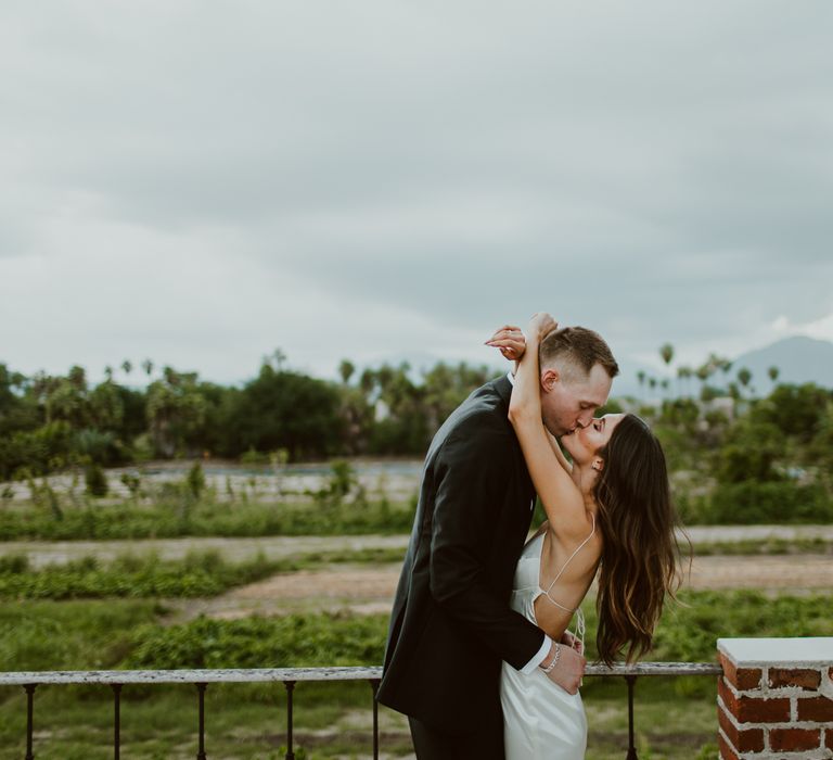 The bride and groom kiss in Cabo