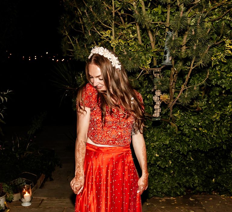 Bride wears traditional red Saari with embellishment 