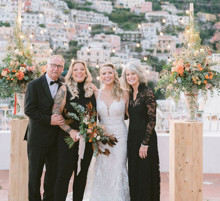 Both brides with their parents at the altar after the ceremony