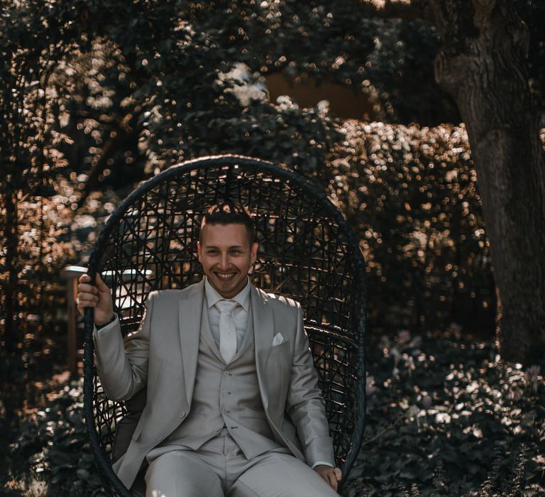 Groom in light grey wedding suit for rooftop wedding