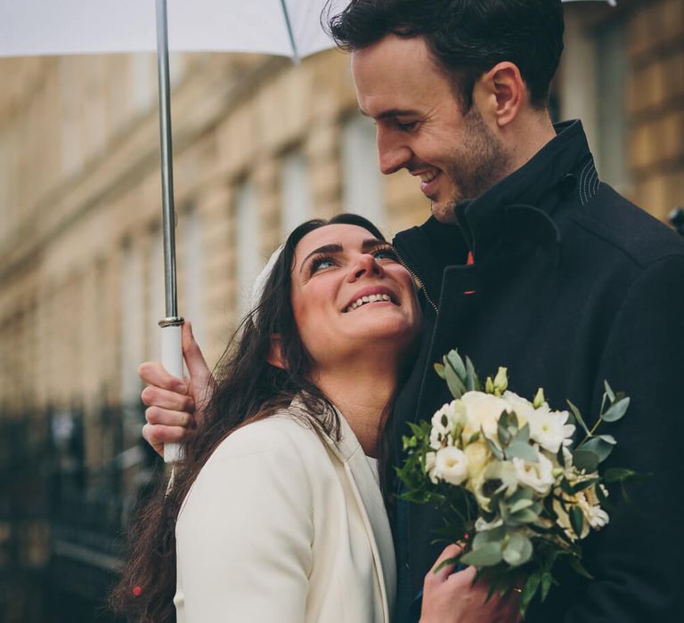 Bride and groom holding each other - bride looks lovingly into grooms eyes