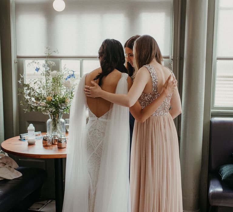 The bride hugging her bridesmaid