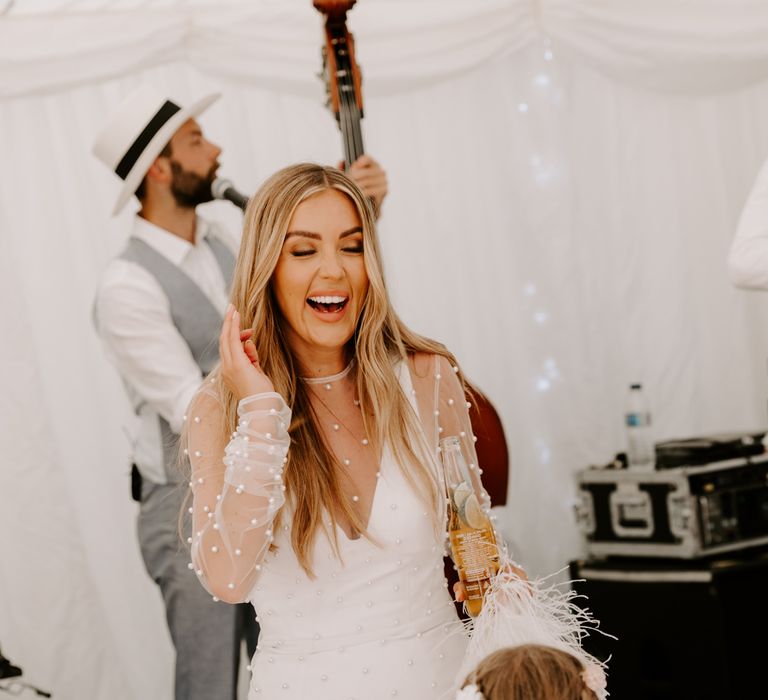 Bride has her hair done on her wedding day