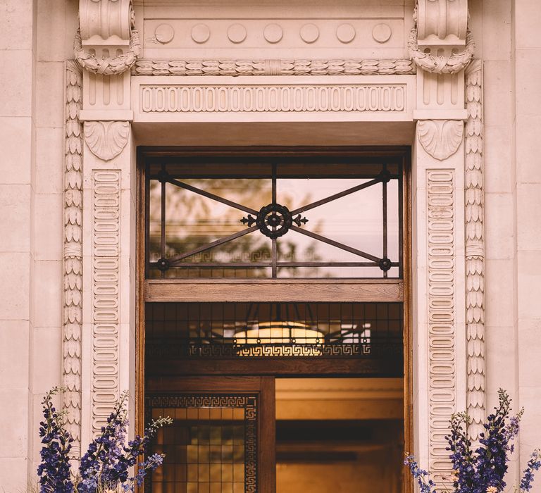 Blue and white wedding flower arrangements outside Old Marylebone Town Hall