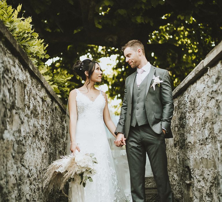 Bride & groom look lovingly at one another on their wedding day at Villa Balbiano 