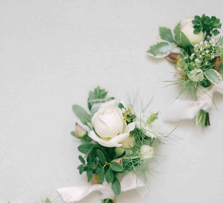 delicate white rose buttonhole flowers 