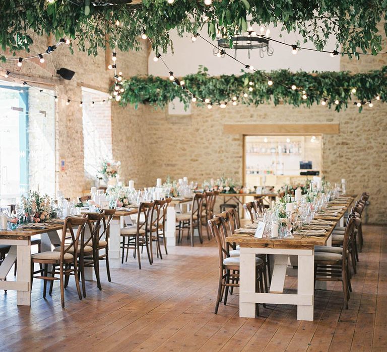 Rustic wedding reception complete with floral installations and festoon lighting