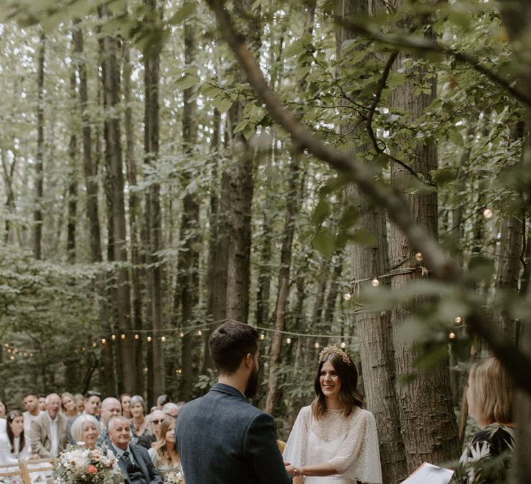 Bride looks at her groom lovingly on her wedding day during ceremony