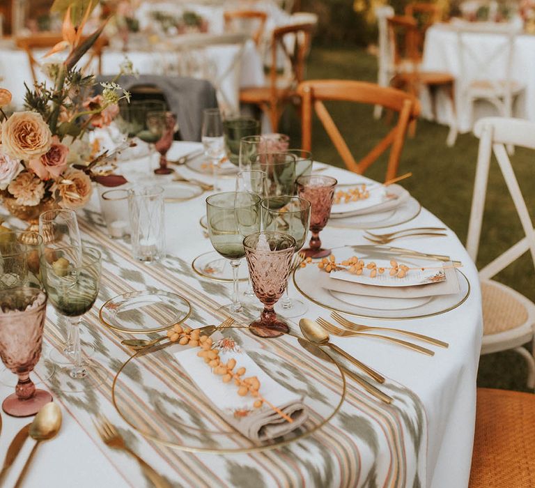 Outdoor reception complete with white table clothes and Moroccan inspired table runner 