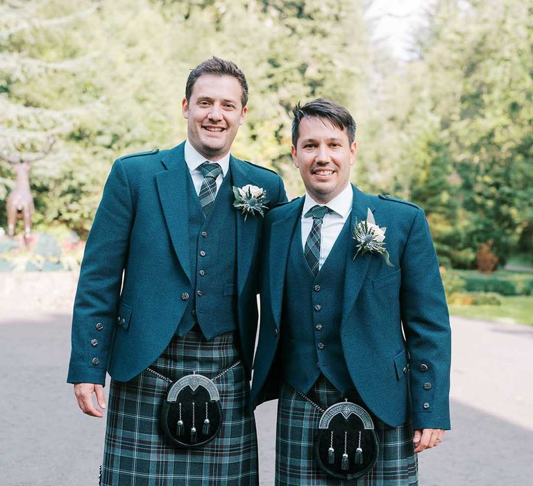 Groom and groomsman in blue and green tartan kilts, sporrans and blue wool blazers 