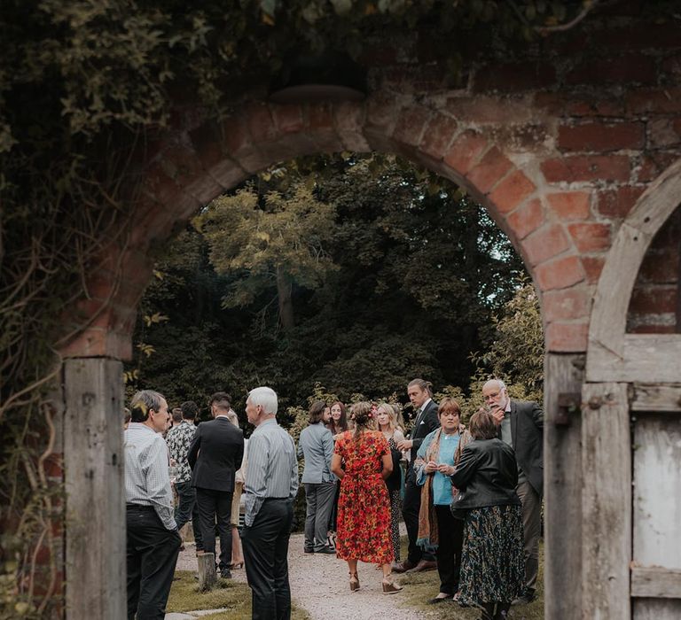 Wedding guests enjoy the ground of Hellens Manor venue