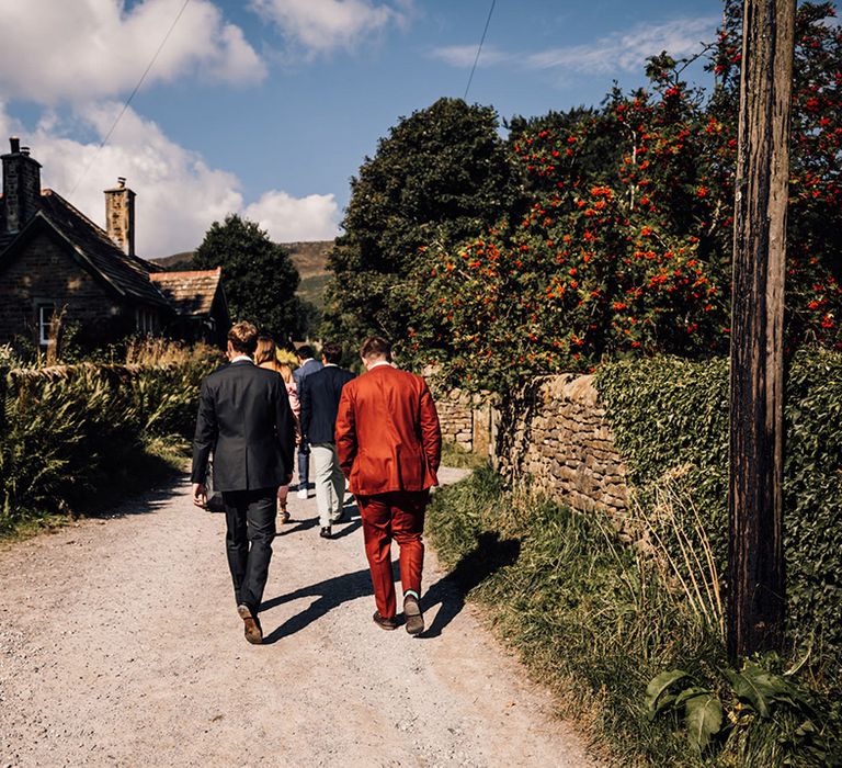 Wedding guests walk to ceremony