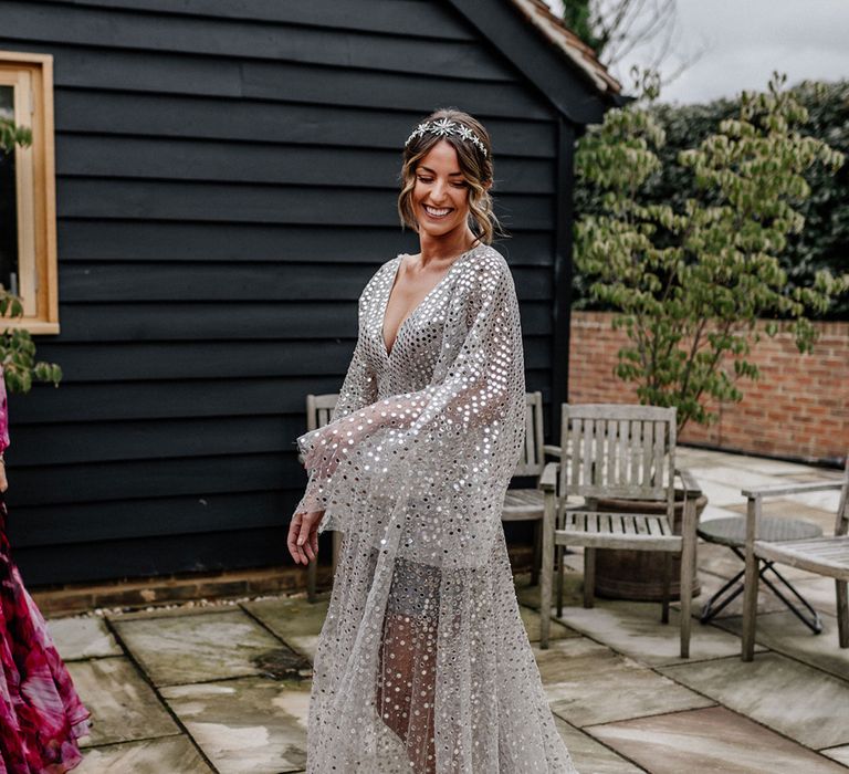 Stylish bride in a Tilly Thomas Lux bridal crown and silver sequin wedding dress 