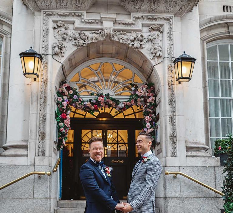 Grooms stand in front of Chelsea Old Town Hall