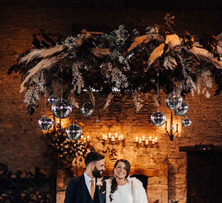 October wedding at Cripps Barn wth hanging dried flower installation and disco balls