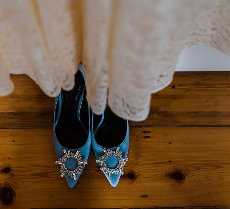 Bride's lace Rixo wedding dress with blue wedding shoes with circular diamanté detail