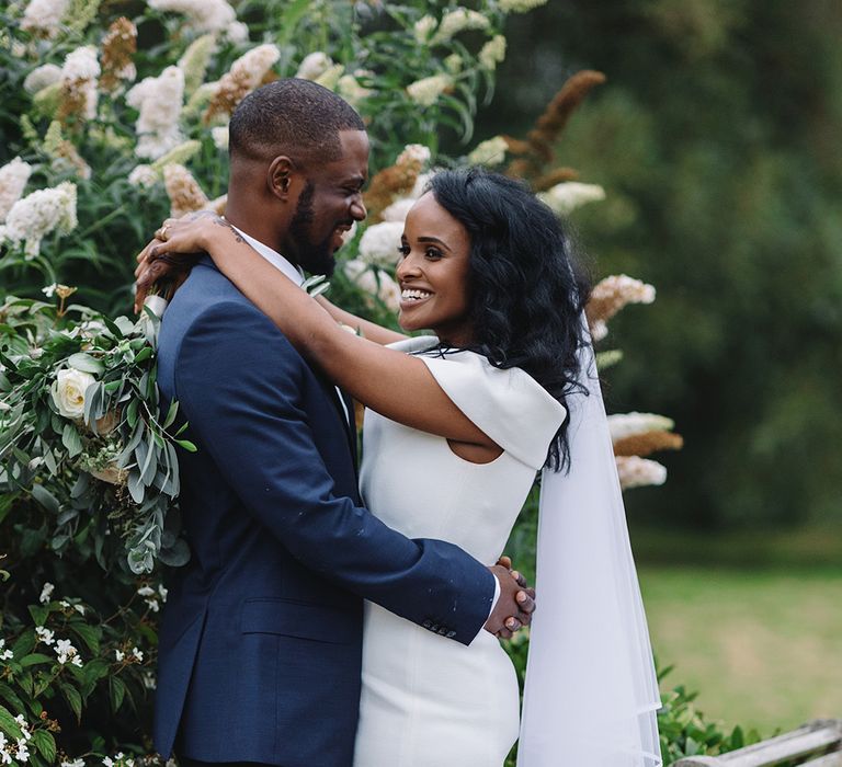  Bride and groom hug each other after Sudanese wedding ceremony at Middleton Lodge