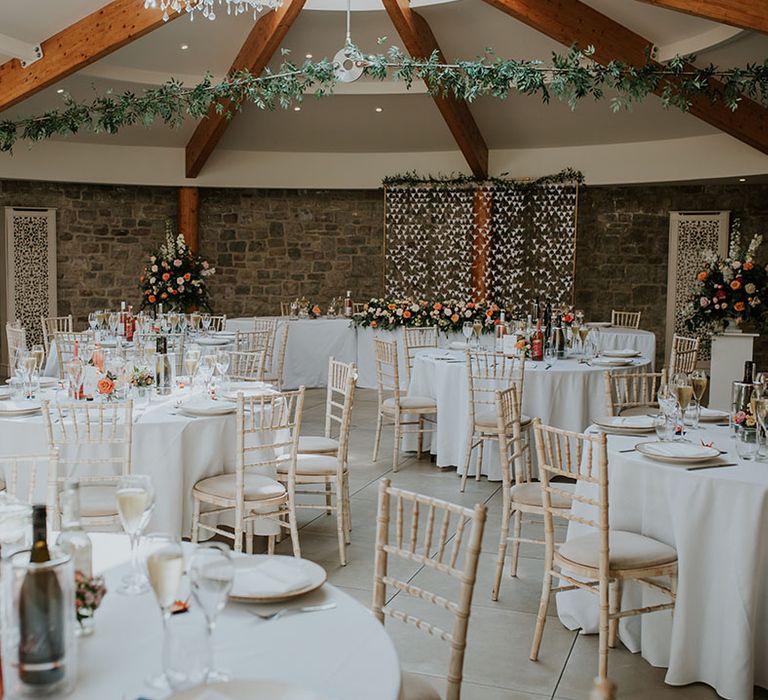 Wedding venue reception area with DIY paper crane decor and decorative greenery