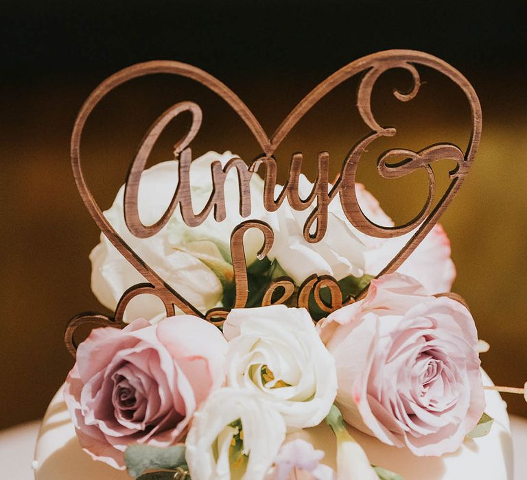 Personalised wooden heart cake topper with the bride and groom's names