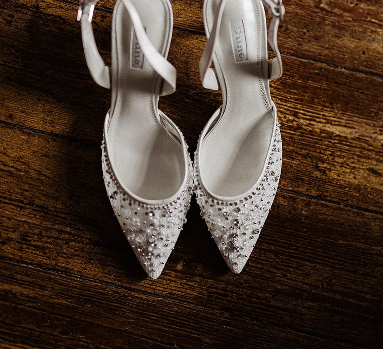 White stiletto ankle strap Dune wedding shoes with beads and diamanté embellishments