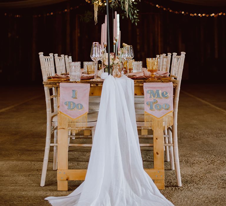 rustic table scape at Montague Farm Hankham with pink fabric banners and flower installation 