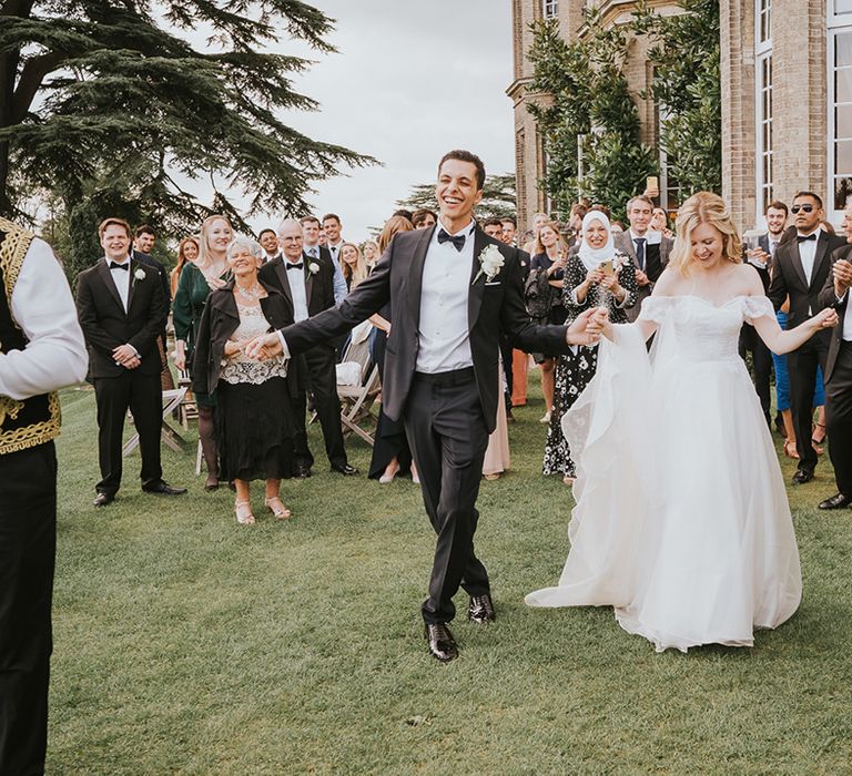 Bride and groom have fun hat their wedding with the Zaffa band 