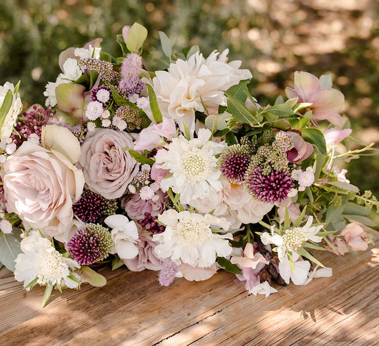 White and purple blooms complete with green foliage for bridal bouquet 