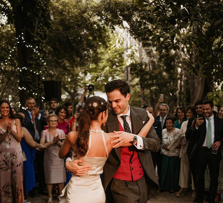 Choreographed first dance with bride in a satin midi wedding dress at outdoor Malaga destination wedding 