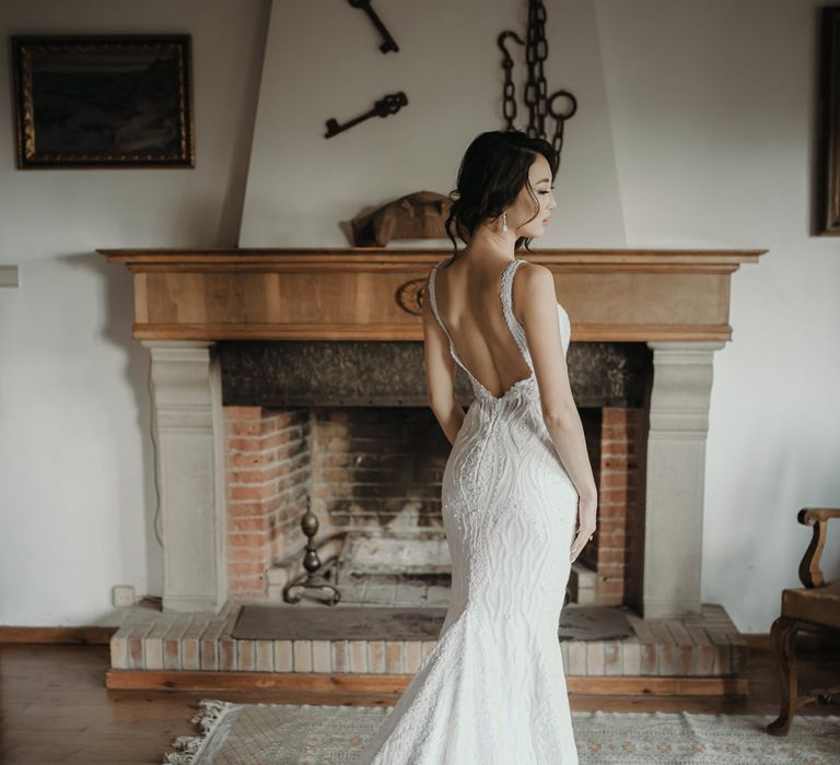 South East Asian bride wears Viero lace embellished fishtail wedding dress finished with low back and scalloped edged train 