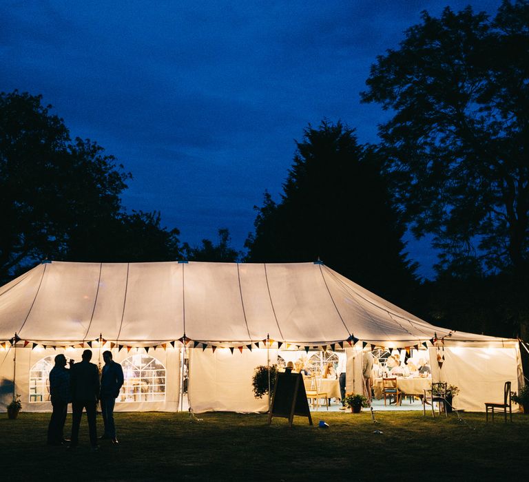 Marquee lit at night for back garden wedding 