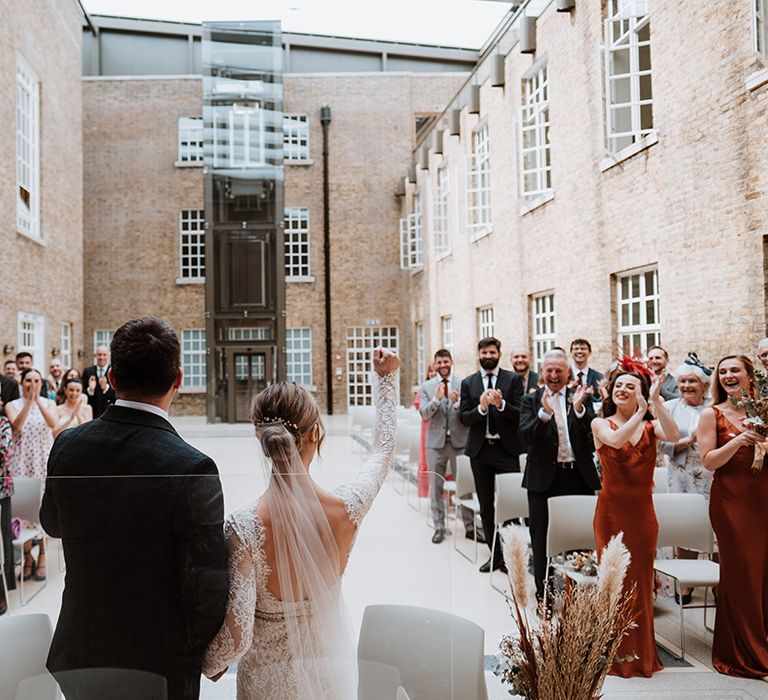 Bride & groom celebrate after wedding ceremony at Hackney Town Hall 