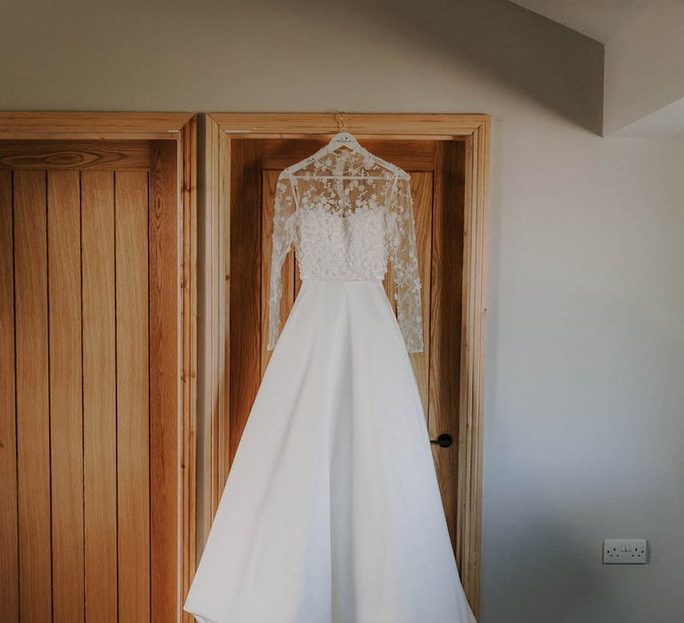 Bride's a-line wedding dress with sheer lace sleeves and a high neckline 