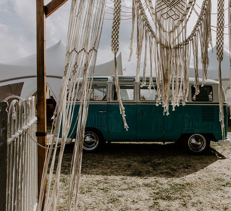 Macrame wedding decor beside vintage VW camper van