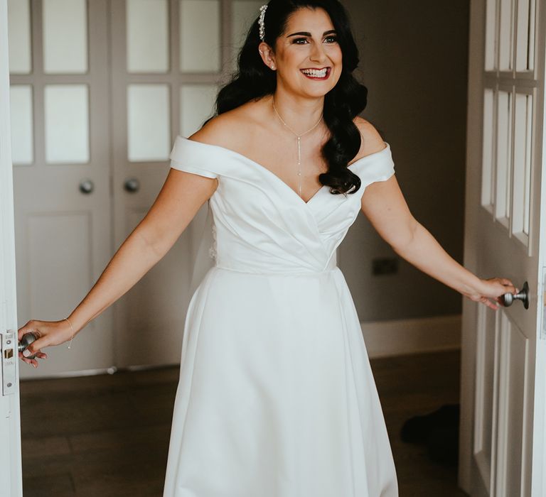 Bride in off-the-shoulder wedding dress with sweetheart neckline and princess styled skirt 