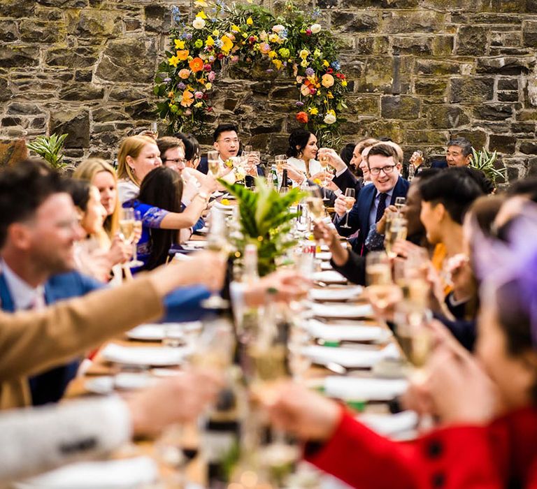 Wedding guests sit at banquet table at Pias Dinam wedding venue during reception with Chinese Tea Ceremony