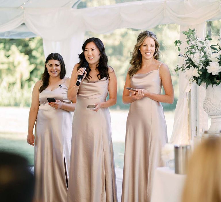 Maid of honour wedding speech in a light pink satin bridesmaid dress