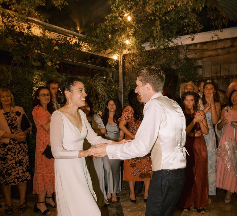 The bride and groom perform their first dance together 